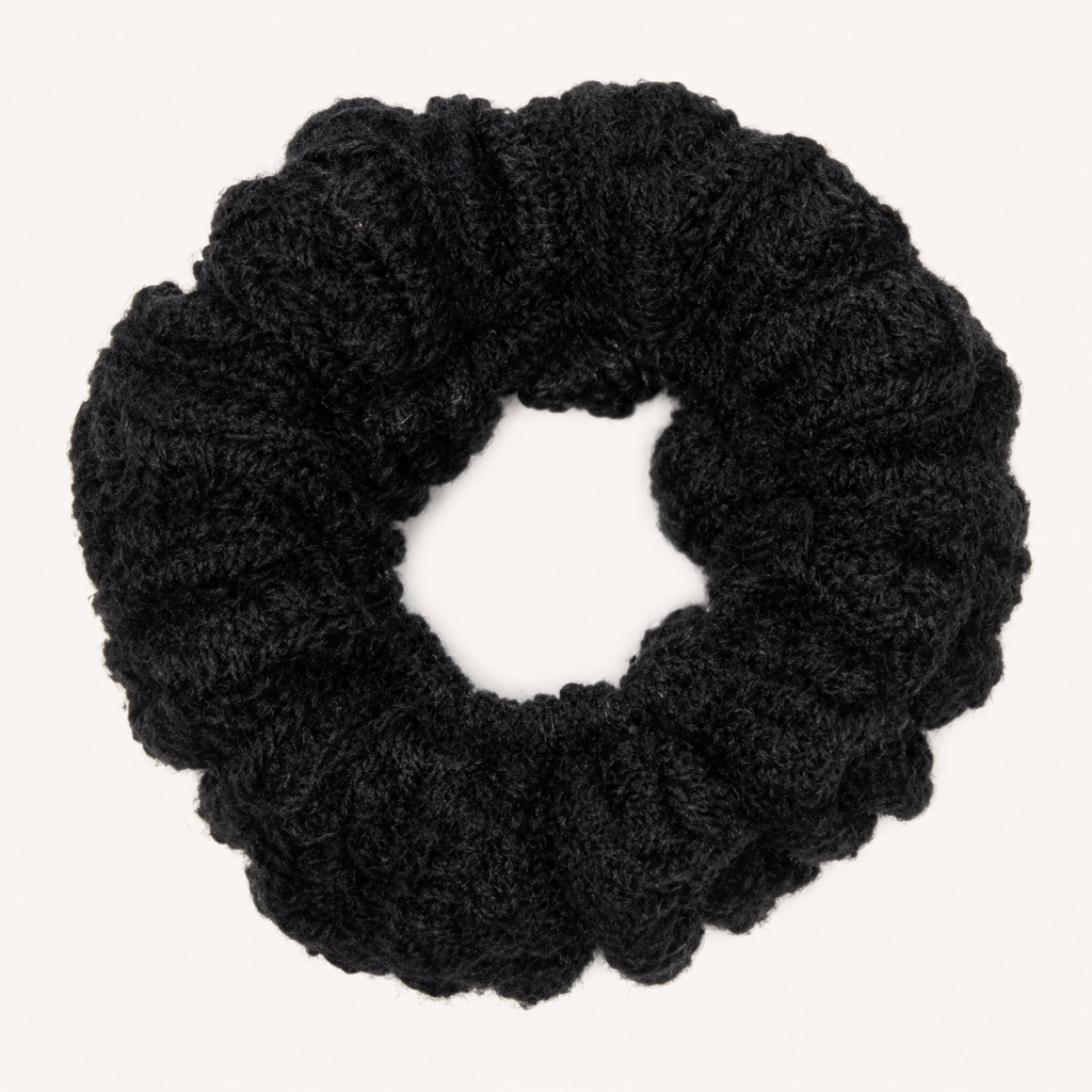 Handmade Jamaican black crochet scrunchie on a clean white background