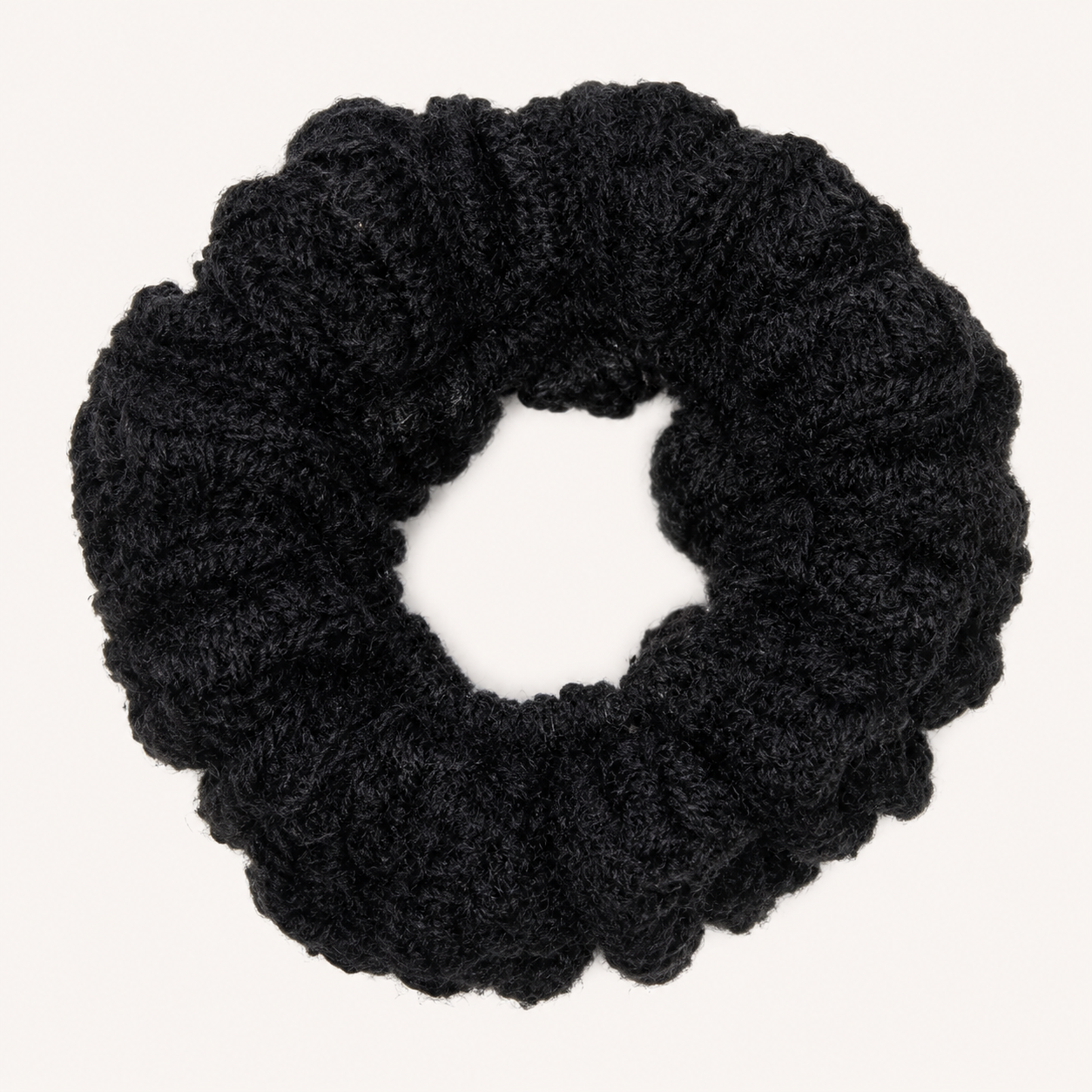 Handmade Jamaican black crochet scrunchie on a clean white background