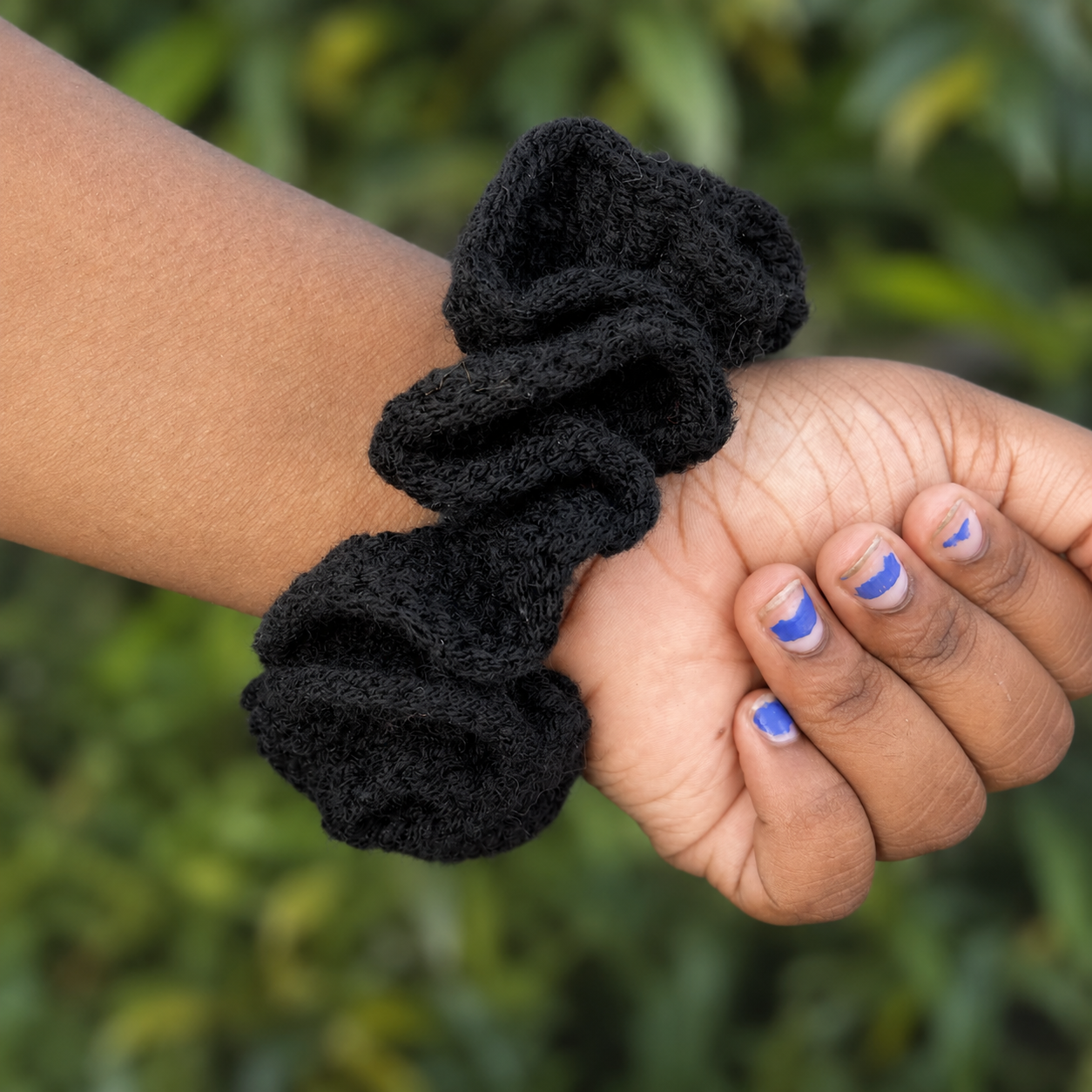 Handmade Jamaican black crochet scrunchie shown worn on the wrist