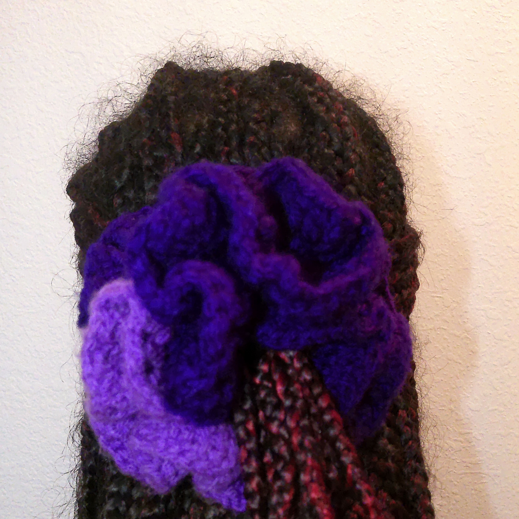 Handmade Jamaican deep purple and lavender crochet scrunchie shown worn in hair
