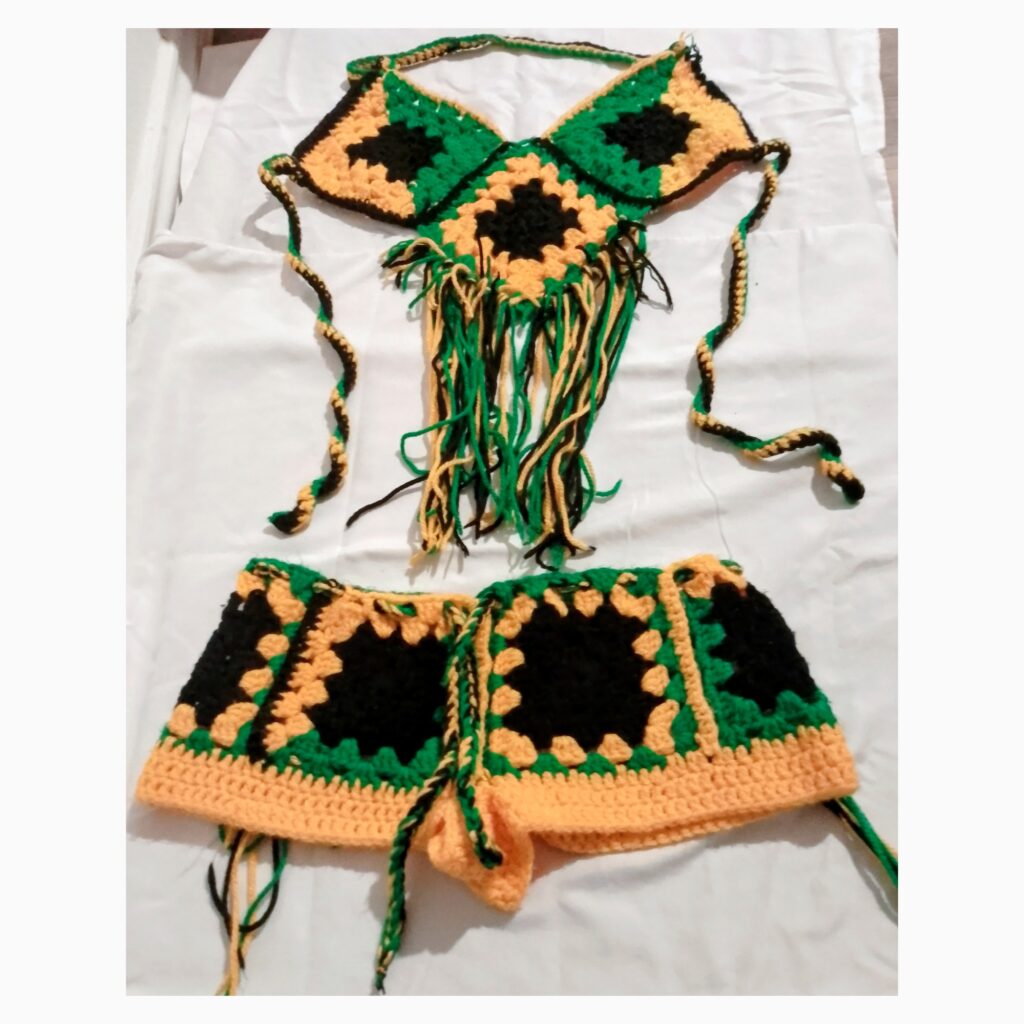 Handmade Jamaican green gold and black fringe crochet halter top and shorts two-piece set flat lay
