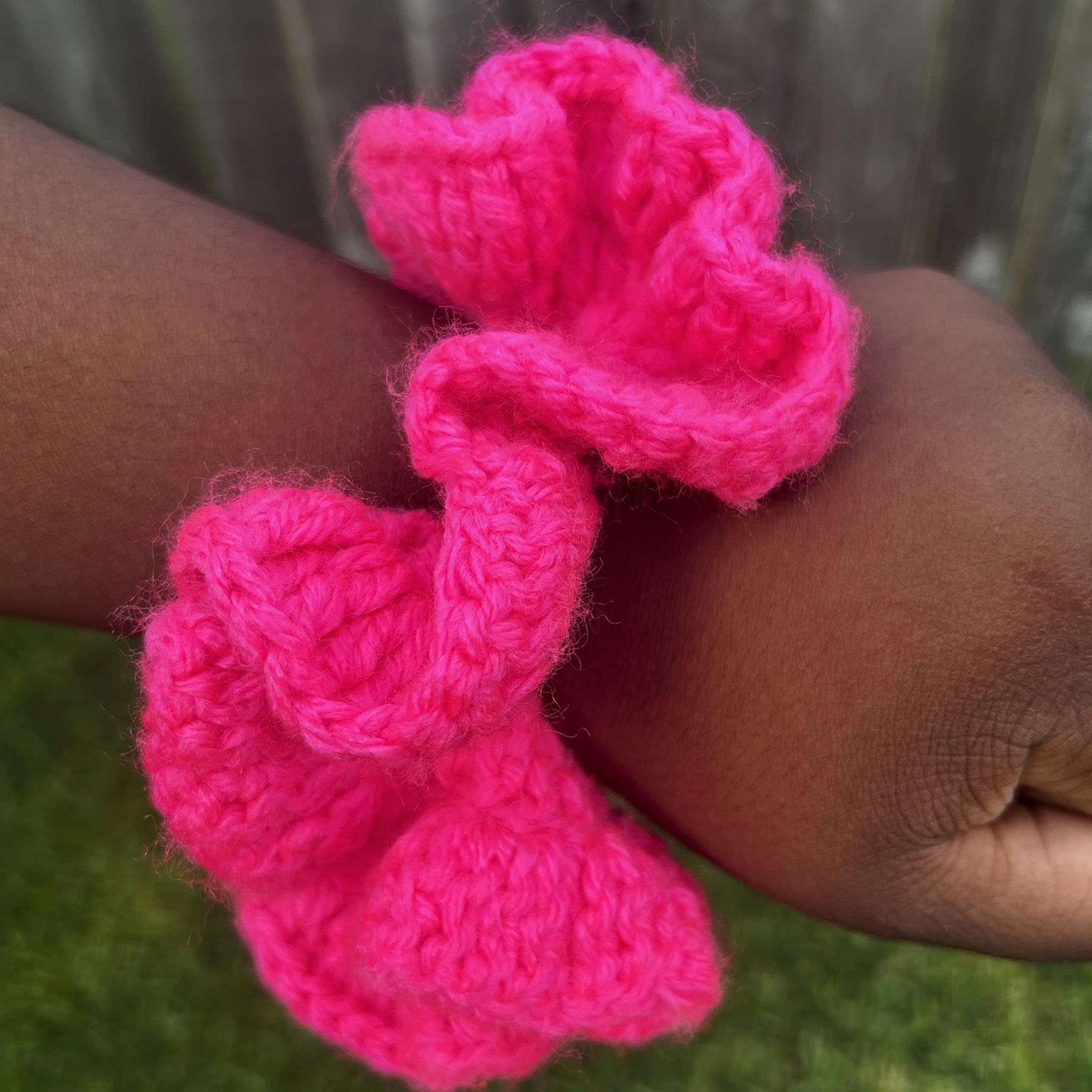 Close detail of handmade Jamaican hot-pink crochet scrunchie
