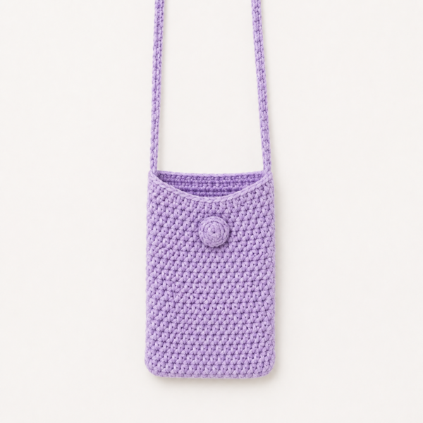 Handmade Jamaican lavender crochet shoulder phone pouch shown with a phone for scale