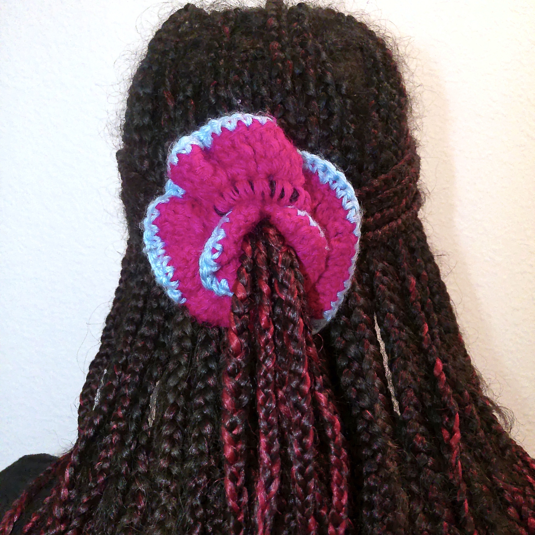 Handmade Jamaican magenta and light-blue crochet scrunchie shown worn in hair