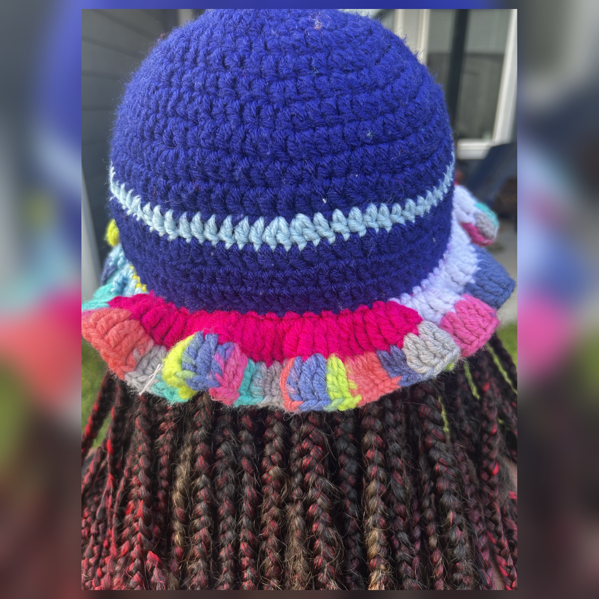 Rear worn view of handmade Jamaican navy blue multicolor curled ruffle crochet hat