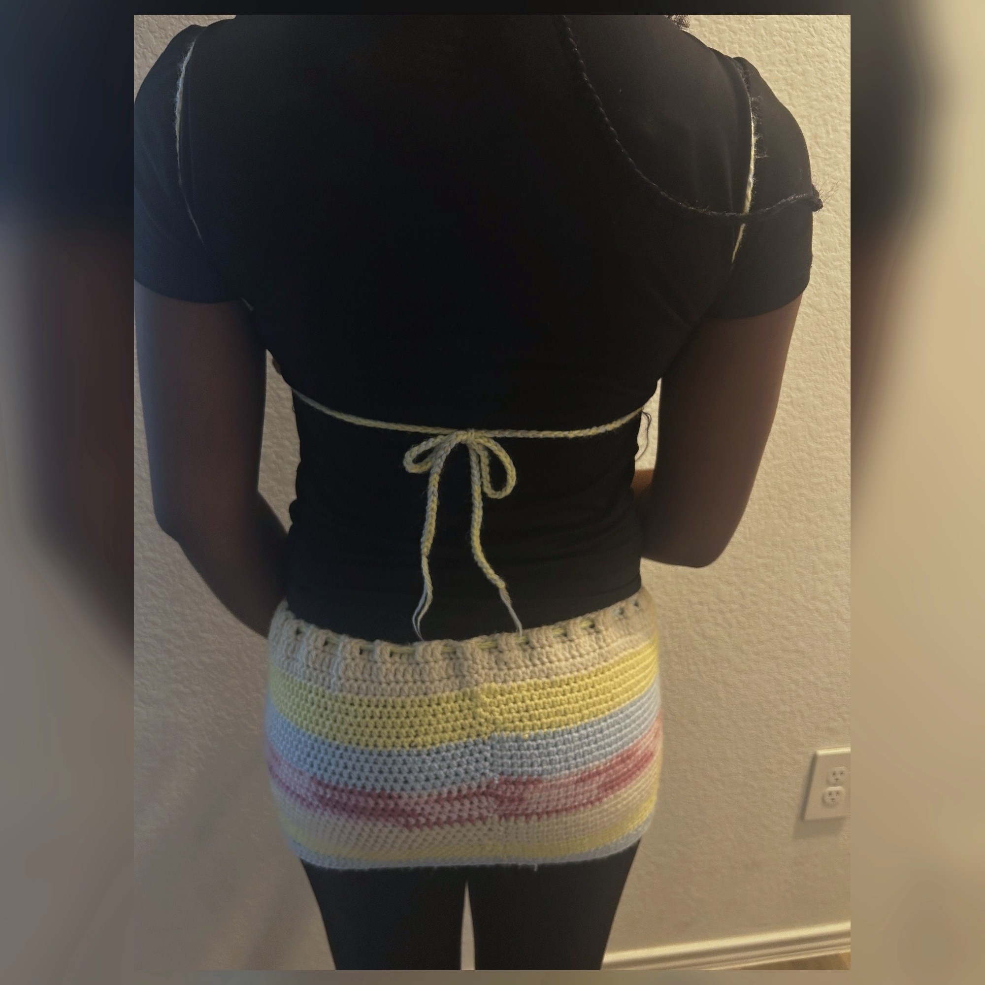 Back view of handmade Jamaican pastel crochet halter top and mini skirt set with adjustable ties