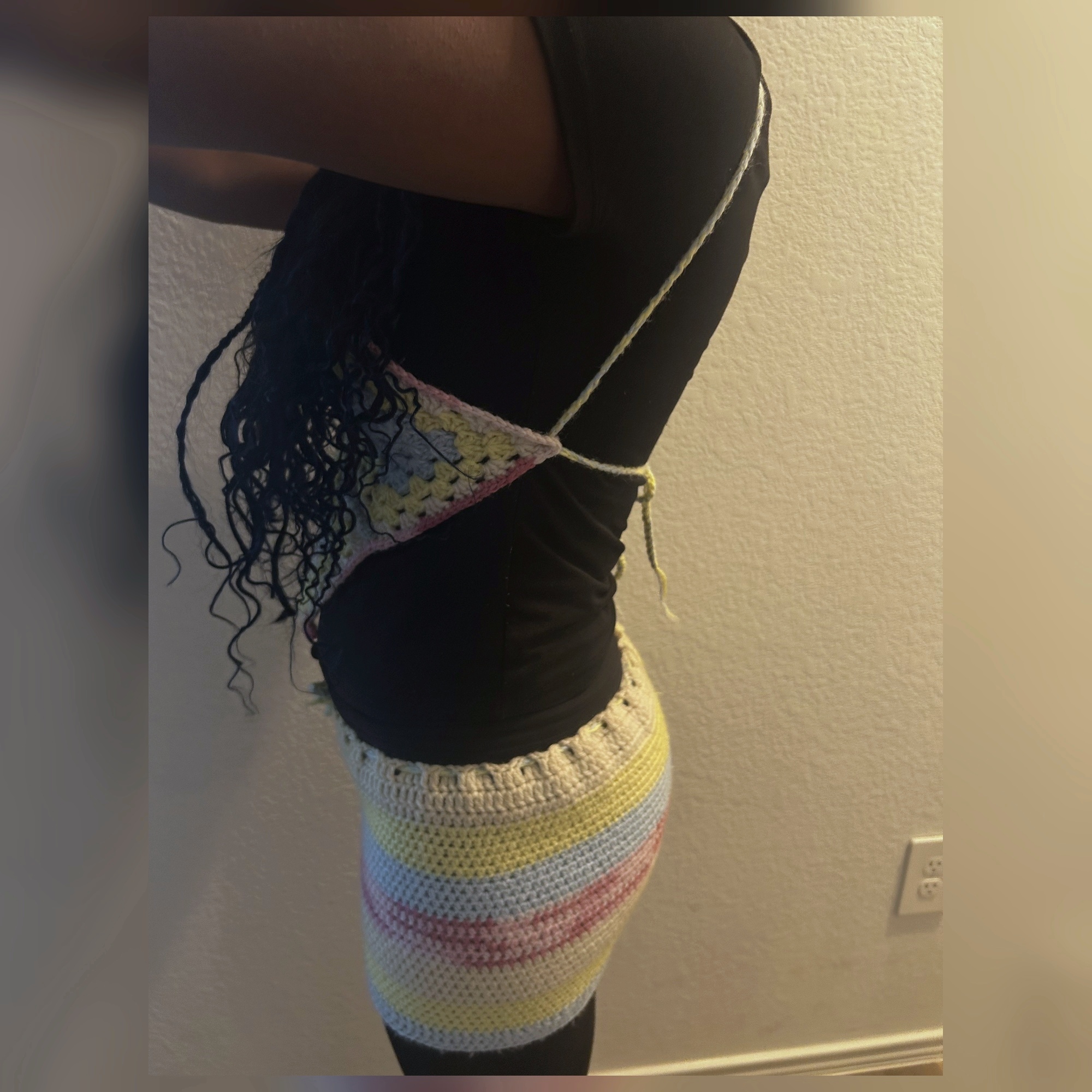 Opposite side view of handmade Jamaican pastel granny-square crochet top and mini skirt set