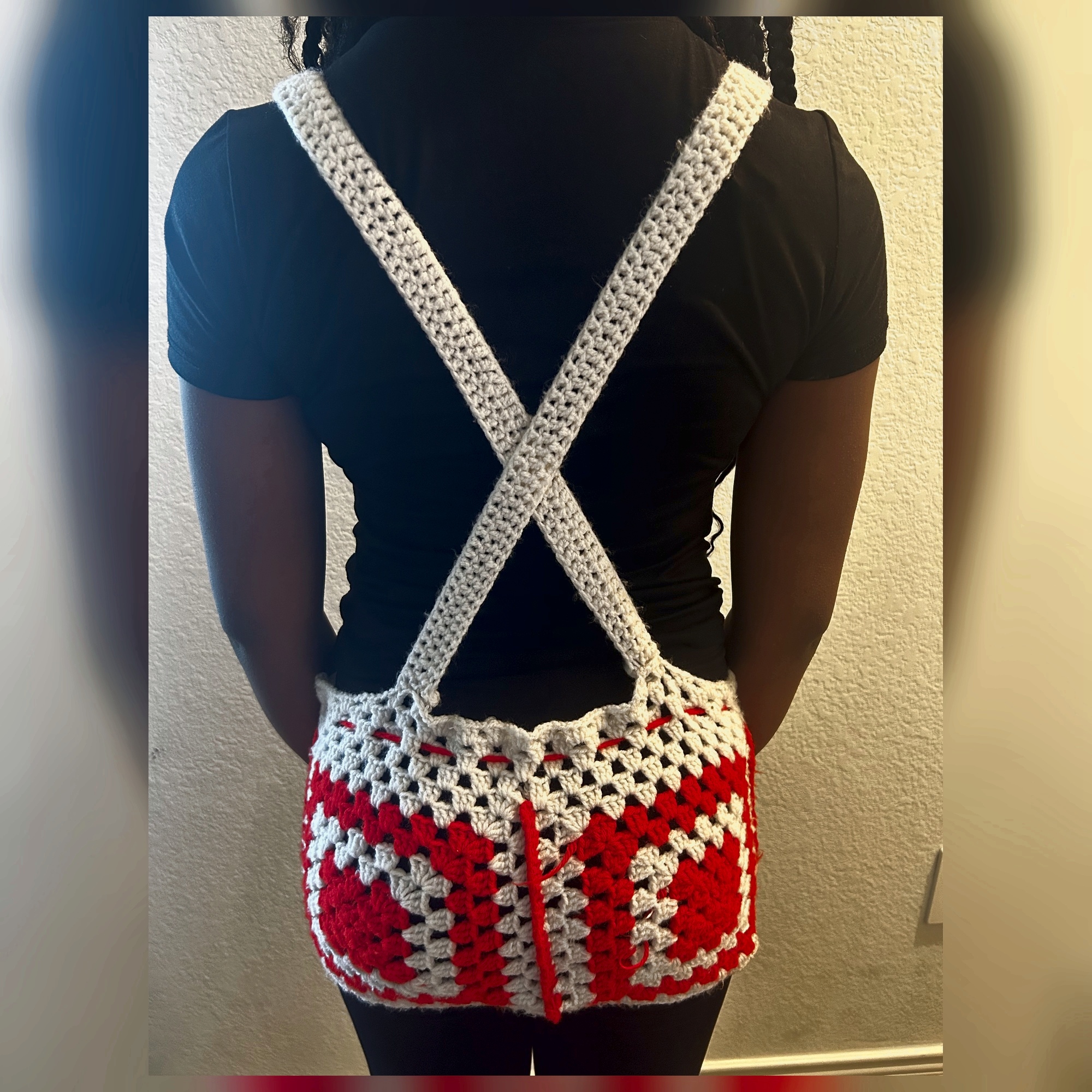 Back view of handmade Jamaican red and cream crochet skirt romper with crossed cream shoulder straps