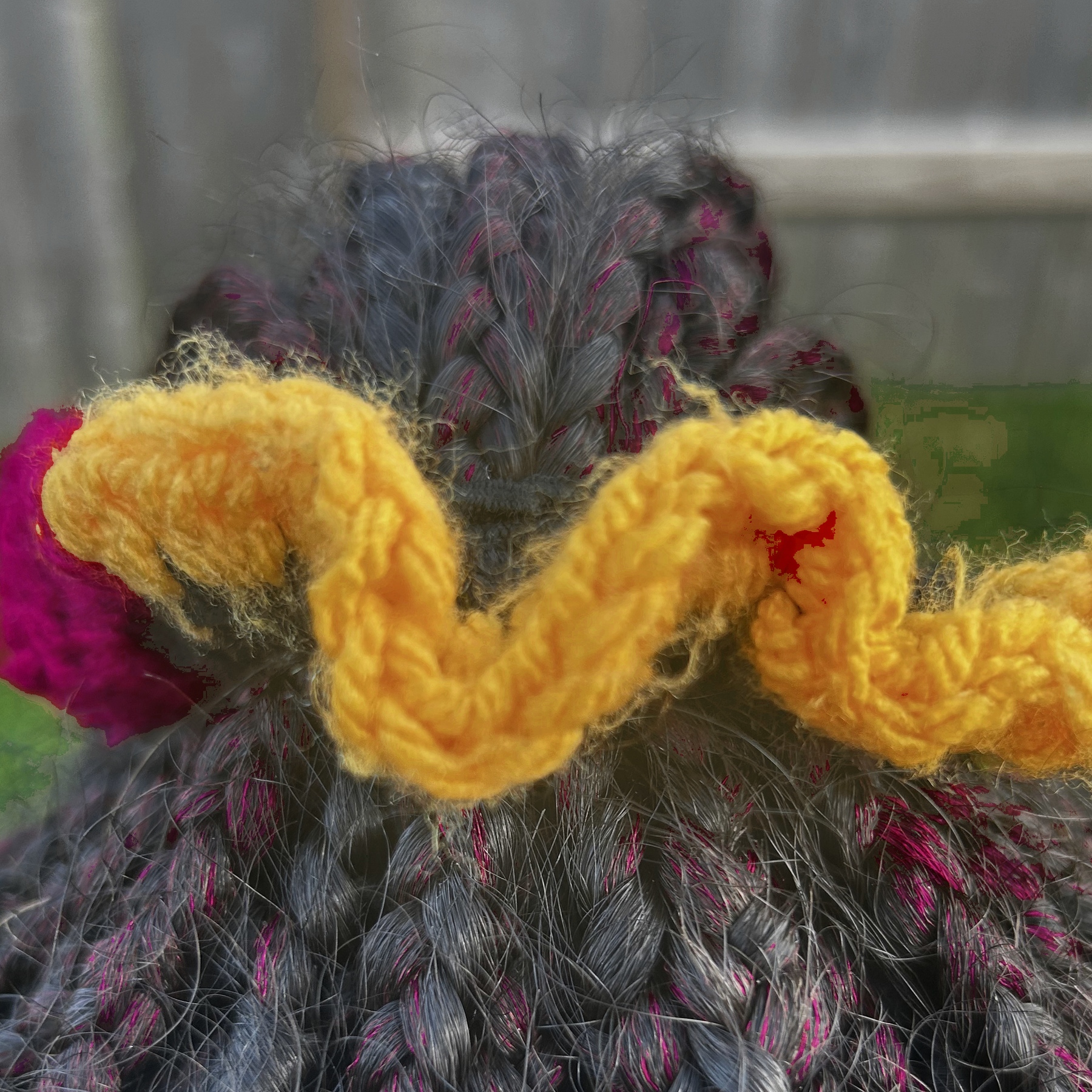 Handmade Jamaican red, gold, green and black colorblock crochet scrunchie shown worn in braided hair