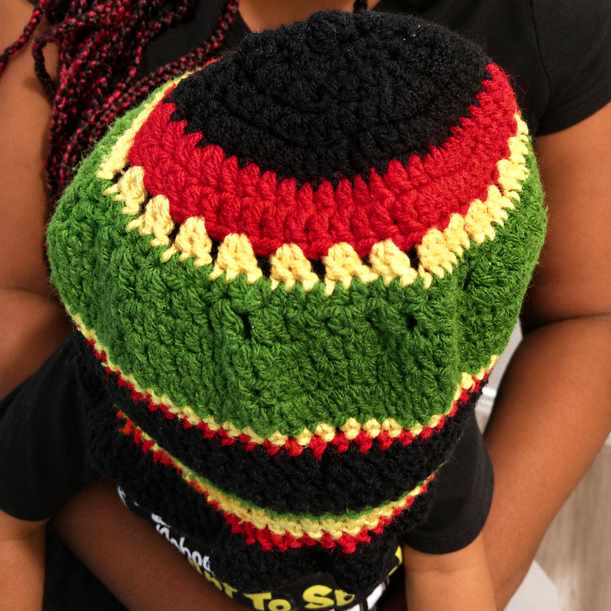 Top crown view of handmade Jamaican red gold green and black crochet bucket hat