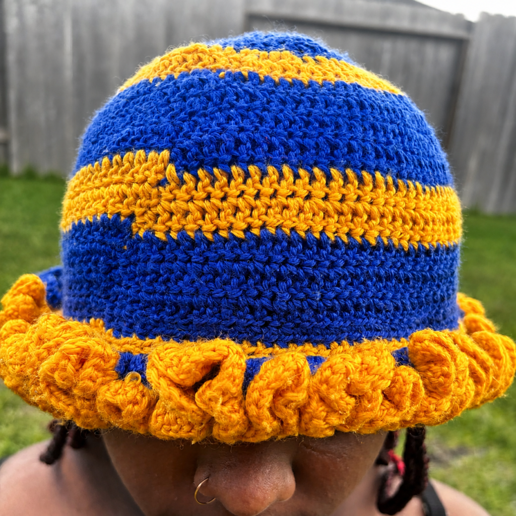 Handmade Jamaican royal blue and golden-yellow crochet hat with striped crown and curled ruffle brim