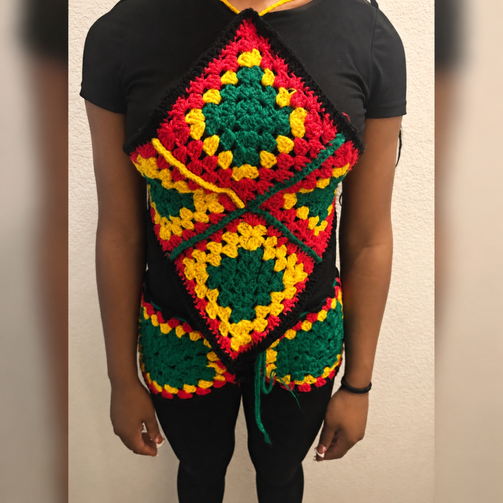 Red, gold, green and black handmade Jamaican crochet apparel set shown being worn