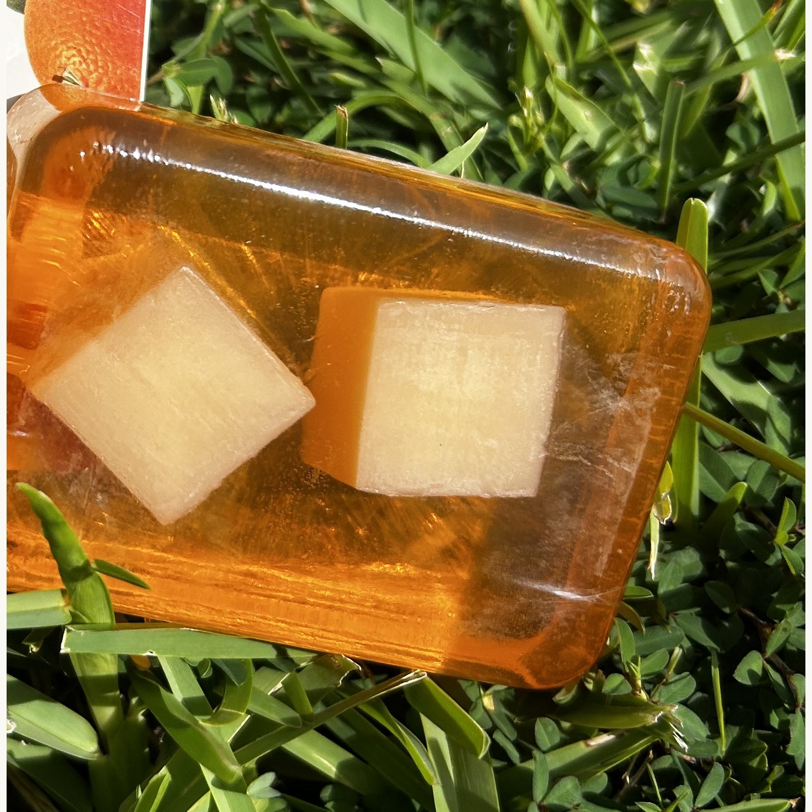Close-up of the translucent orange VitalLeaves Citrus Glow face and body cleansing bar